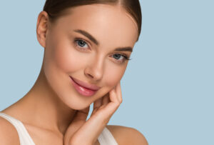 Woman with smooth glowing skin touching her face after HydraFacial treatment in Miami HYDRAFACIAL in Miami, FL