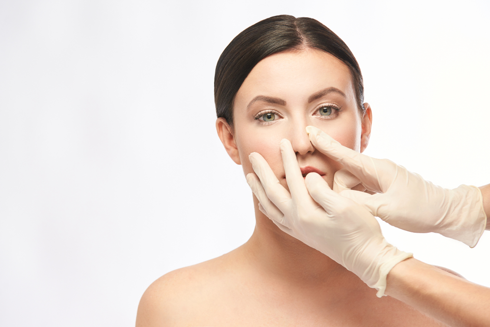 Patient having her nose examined by her provider to deterine if dermal fillers or plastic surgery should be used.